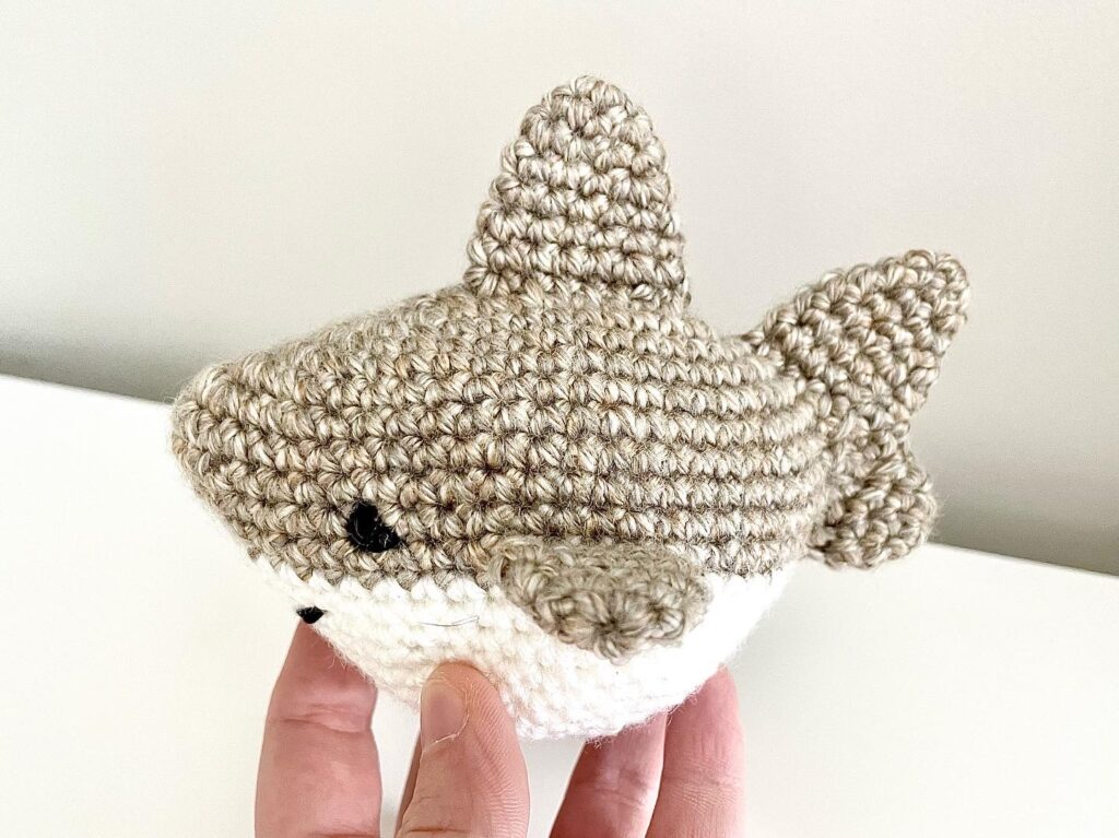 crochet baby shark in tan and white side view
